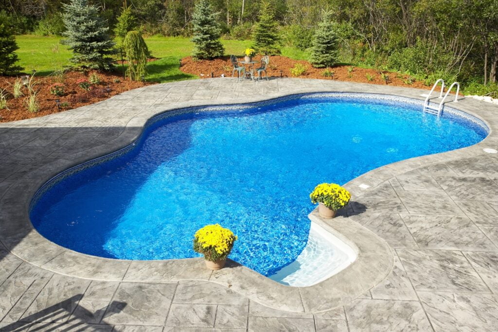 A backyard pool with a unique shape.