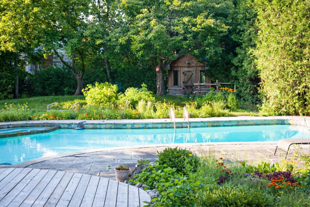 A uniquely-shaped pool in a backyard.