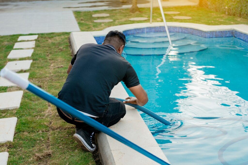 A man closing a pool for winter.