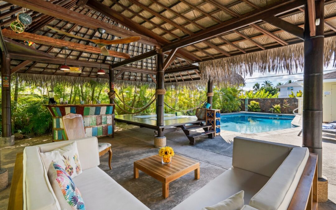 An outdoor living area with a pool cabana.