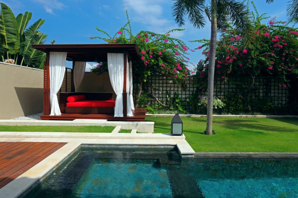 A pool cabana with a wooden deck.