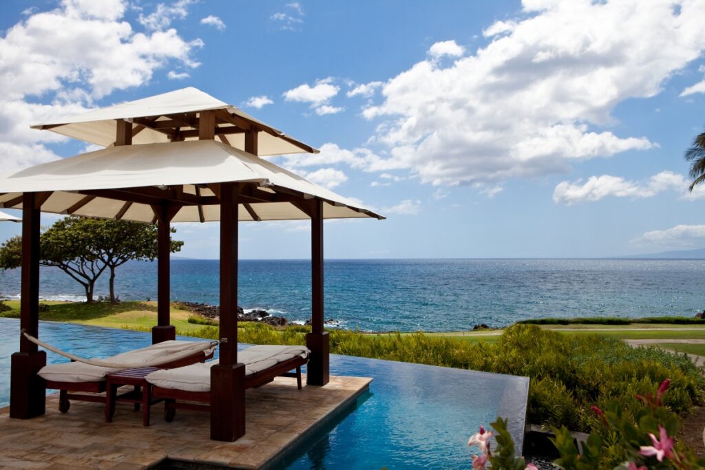 A pool cabana overlooking the ocean.