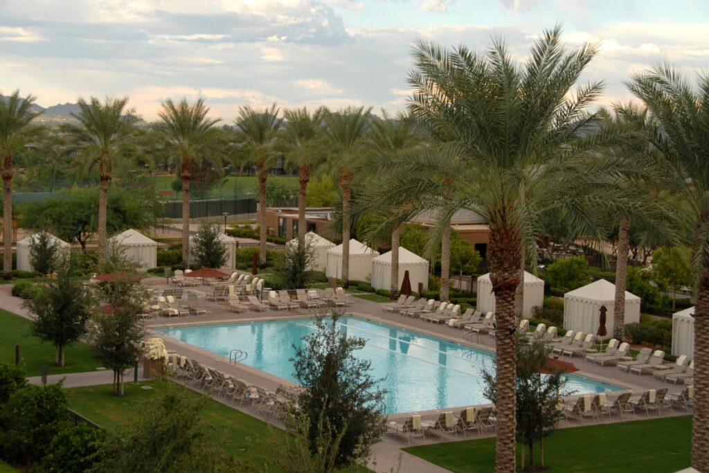 A pool in a resort with a cabana available for guests.