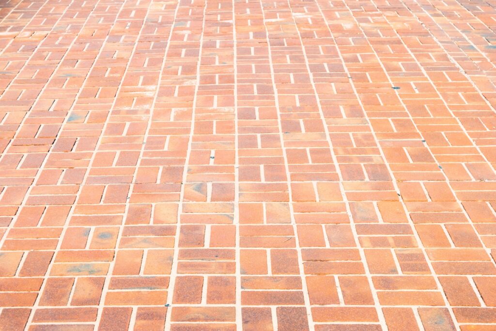 A brick walkway made with bricks as pool deck material.