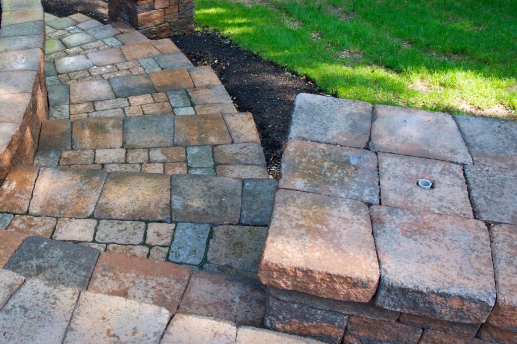 A patio with a stone walkway and steps, perfect for adding to your pool deck material.