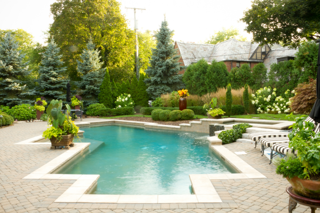 A modern swimming pool in a backyard with a geometric design.