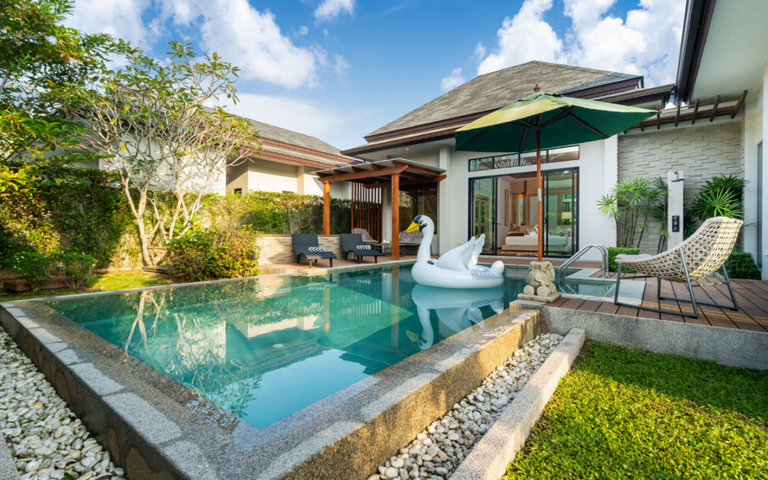 A modern swimming pool harmoniously integrated into the backyard of a house, showcasing innovative landscaping ideas.