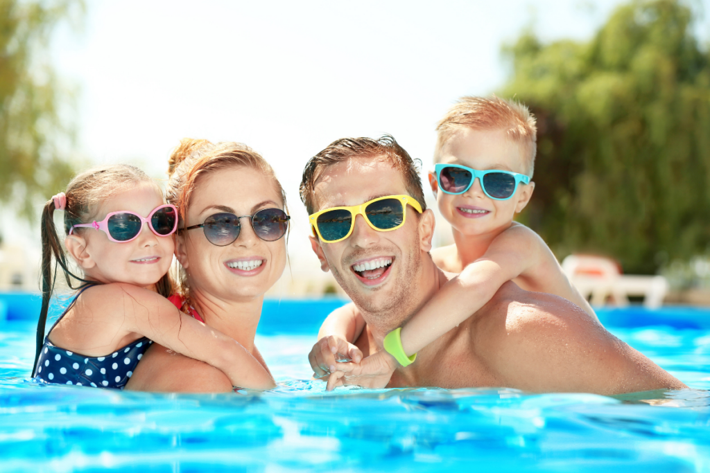 A family enjoying the benefits of smart pool technology while wearing sunglasses in a swimming pool.