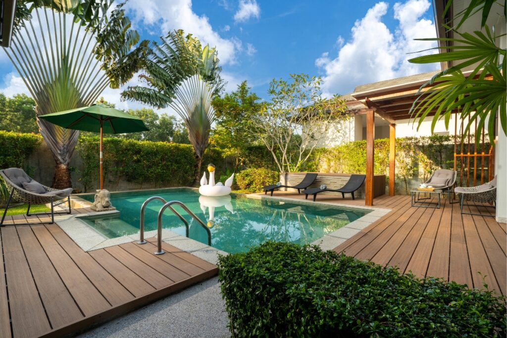 A wooden deck with energy-efficient pools and lounge chairs.