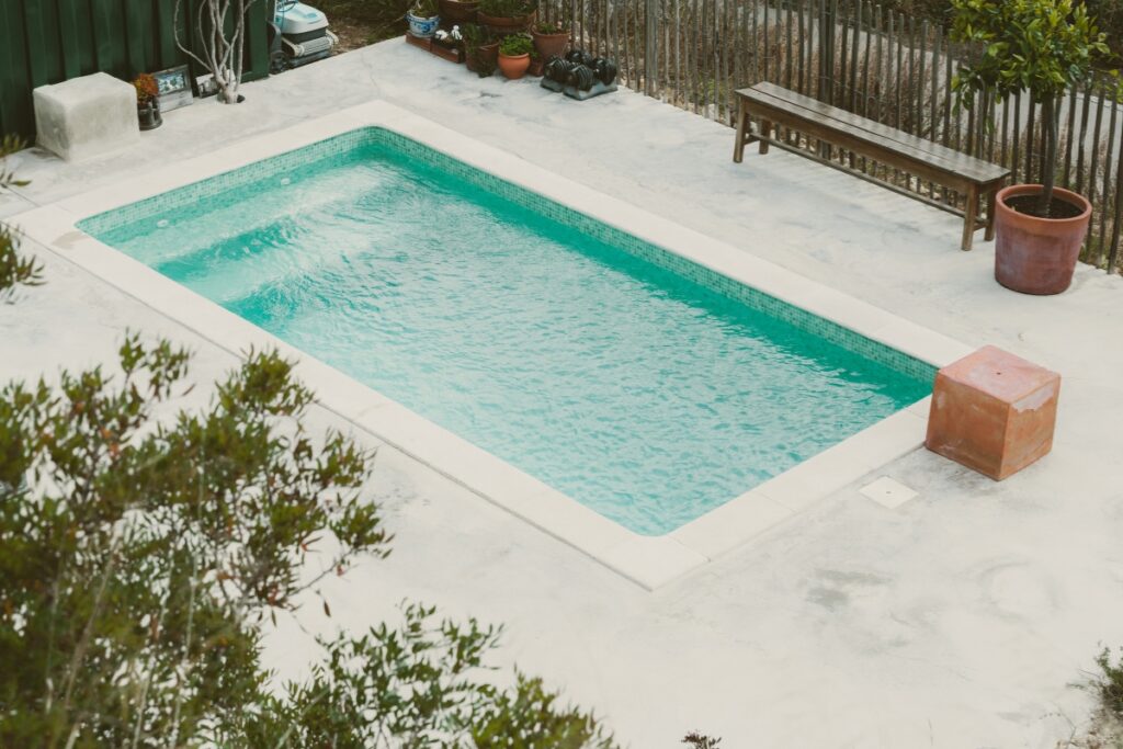 An energy-efficient swimming pool in a backyard.
