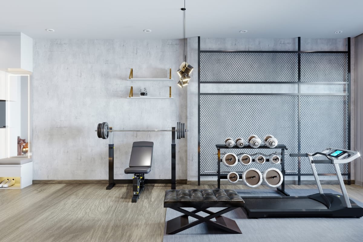 A modern home gym with a treadmill, bench press, free weights, and a shelf on the wall in a bright room seamlessly complements its adjoining space—a luxurious gym with pool for the ultimate fitness experience.