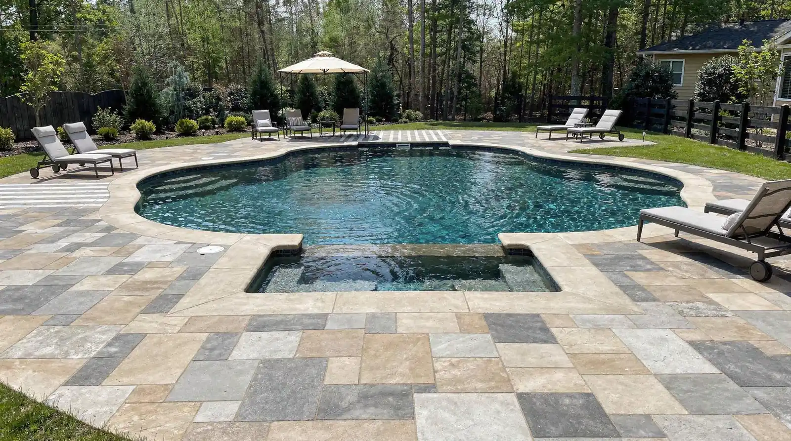 Many homeowners are moving away from plain concrete toward cooler, lower-maintenance alternatives such as pavers